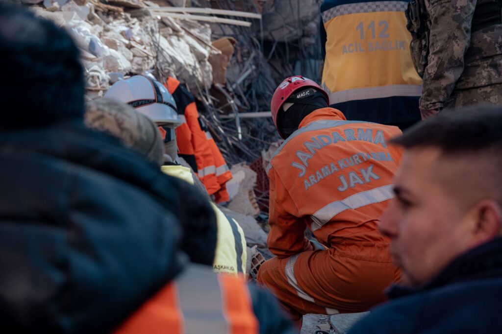 Rescue operation in Antakya, Türkiye, with gendarmes working amidst earthquake ruins.