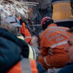 Rescue operation in Antakya, Türkiye, with gendarmes working amidst earthquake ruins.