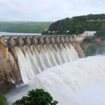 Majestic view of water flowing over Srisailam Dam in Andhra Pradesh, India.
