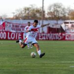Soccer player in motion during a match, capturing the intensity of the game.