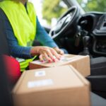Courier organizing parcels inside a vehicle, highlighting the delivery process. Perfect for logistics themes.