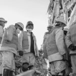 Rescue workers at earthquake site in Kahramanmaras, Turkey, wearing protective gear.