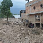 Destruction from landslide in Mocoa, Colombia, showing damaged buildings and debris.