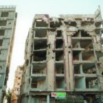 Rubble and decay of a war-damaged building in Homs, Syria, highlighting urban devastation.