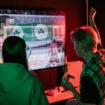 Two friends enjoying an exhilarating video game session indoors, captured with vibrant lighting.