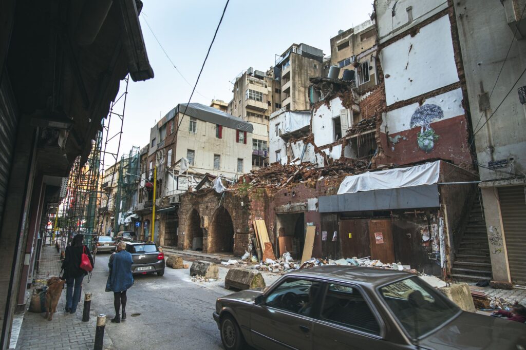 Street scene in Beirut depicting building damage and recovery efforts after the port explosion.