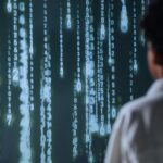 An individual viewing glowing numbers on a screen, symbolizing technology and data.