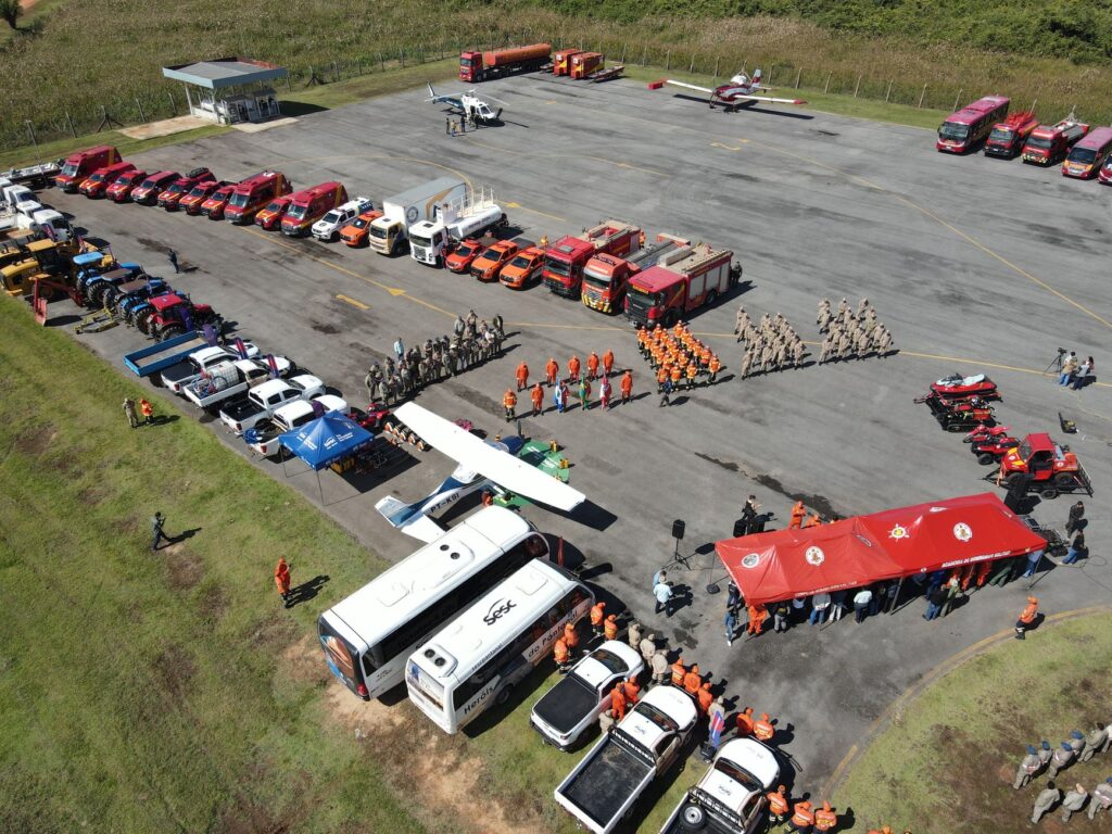 Aerial view of firefighters and equipment in training at an outdoor facility.