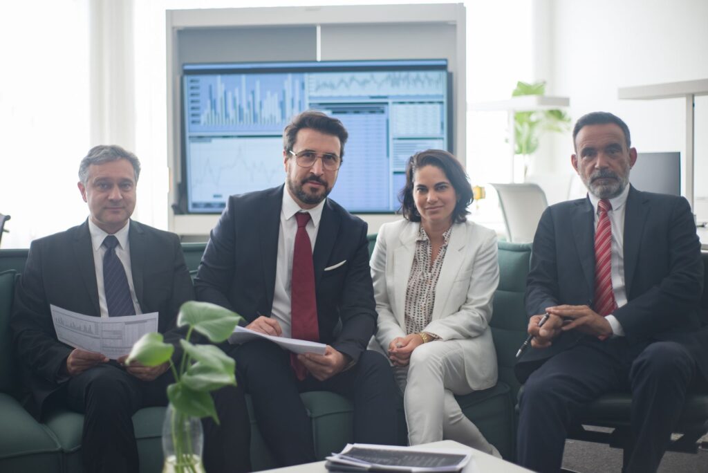 Professional team in corporate attire ready for a meeting, engaged in discussion.