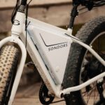 Close-up image of a Sondors electric bicycle with fat tires parked outdoors.