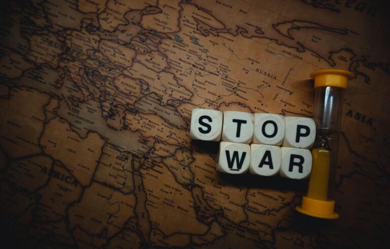 A powerful message 'Stop War' displayed on a vintage world map with an hourglass, symbolizing urgency and global issues.