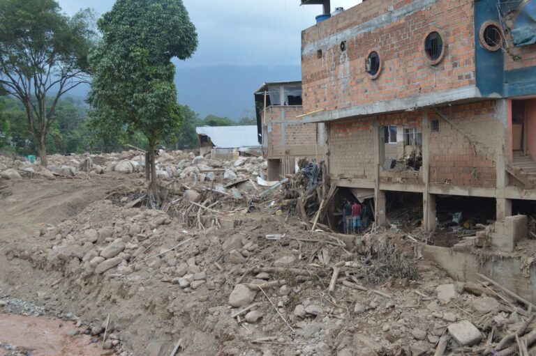 Destruction from landslide in Mocoa, Colombia, showing damaged buildings and debris.