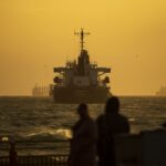 Silhouetted ships navigate the Bosporus Strait at sunset, creating a dramatic scene in Istanbul.