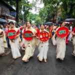 Women in traditional attire participate in Rath Yatra parade in Kolkata, India.